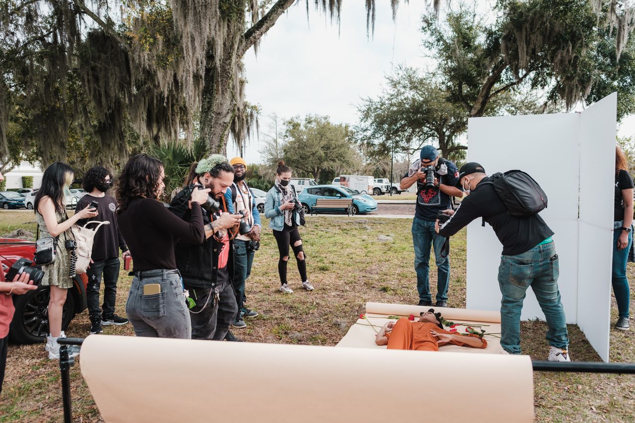 Group of photographers participating in an outdoor photoshoot workshop in a park in Orlando, Florida.