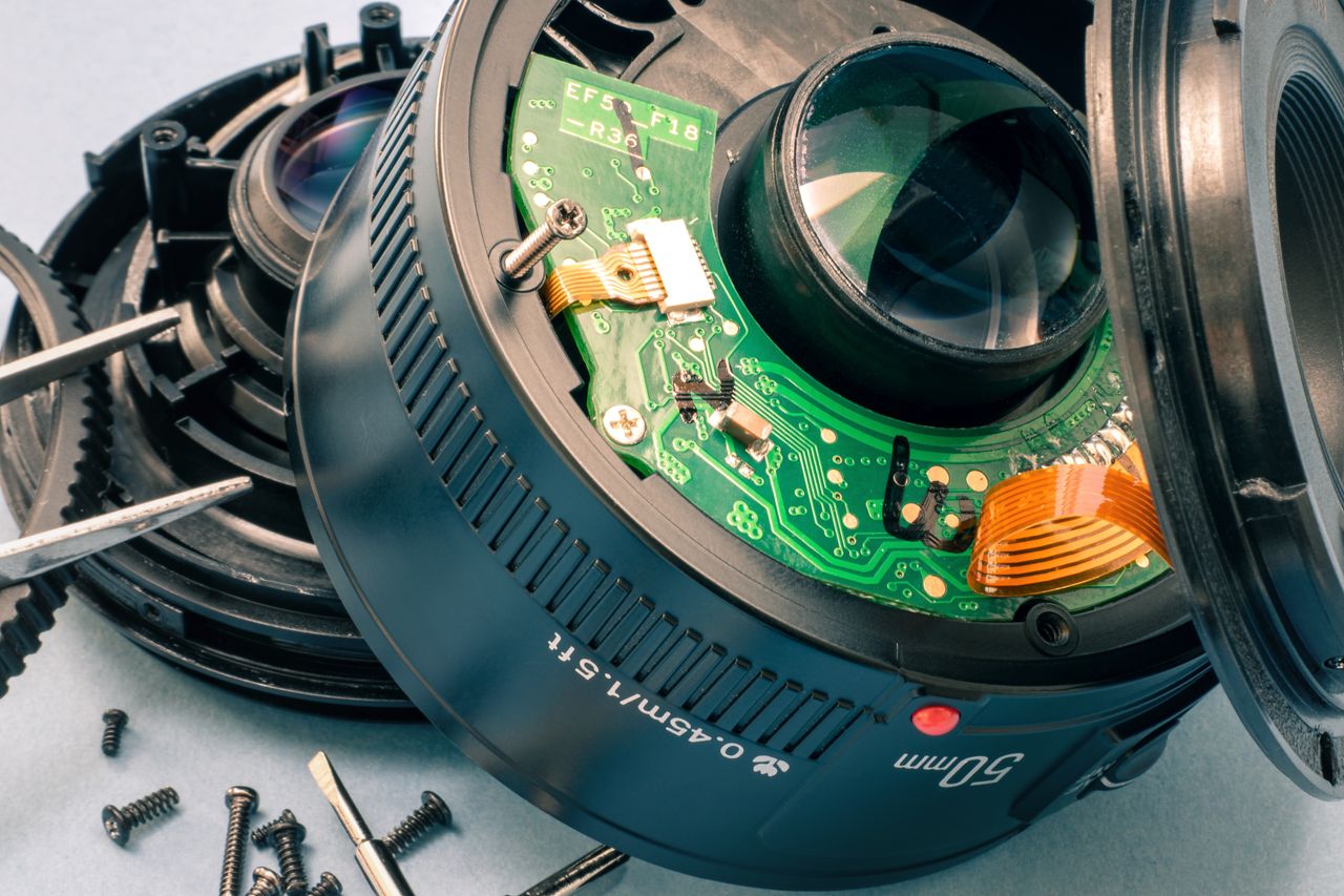 Detailed macro of a disassembled camera lens showing internal circuitry and components.